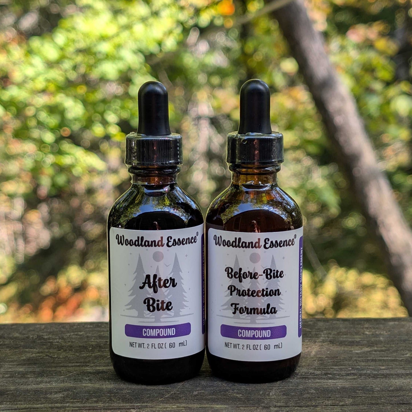 Two bottles of Woodland Essence on a wooden surface with a natural background