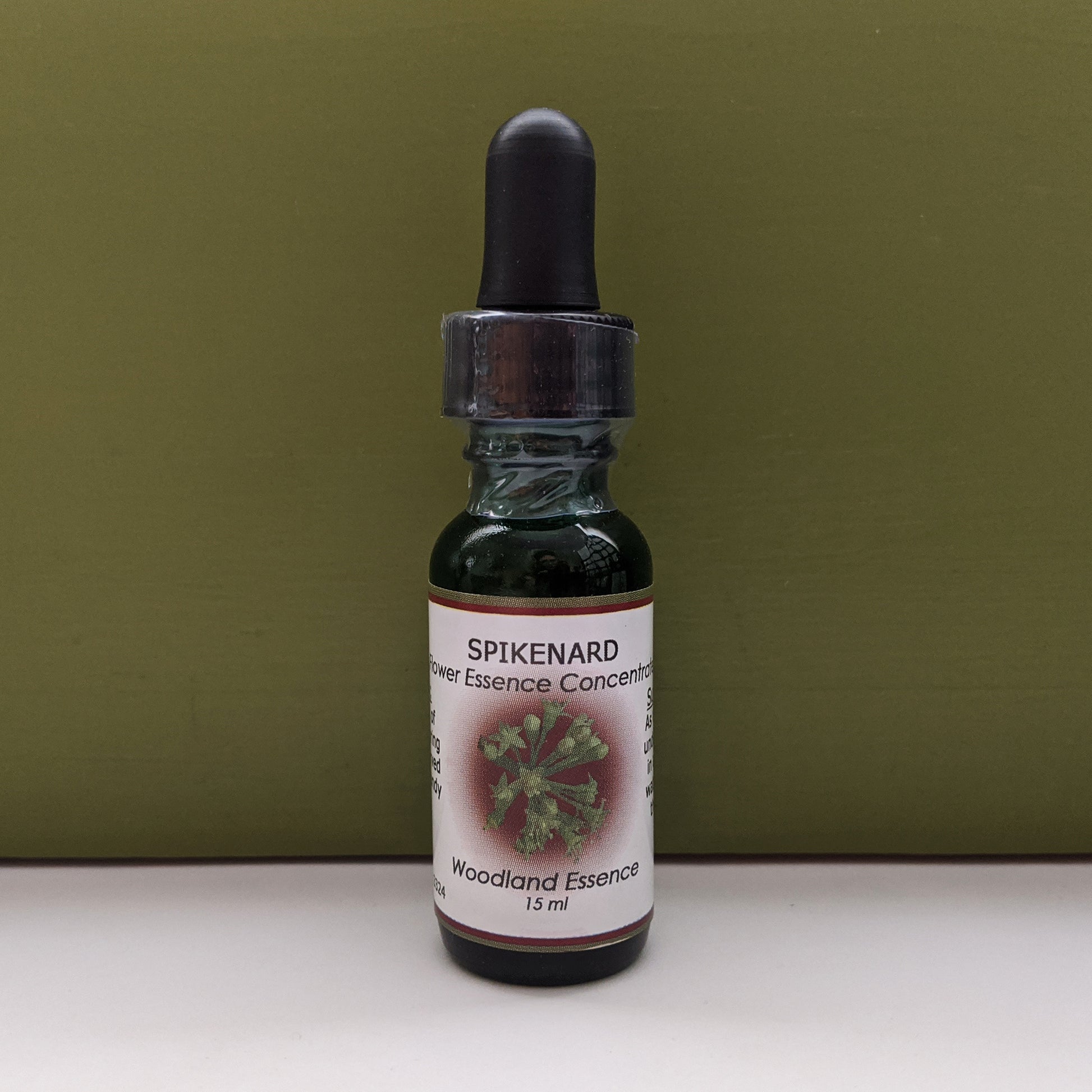 Bottle of Spikenard Flower Essence against green background