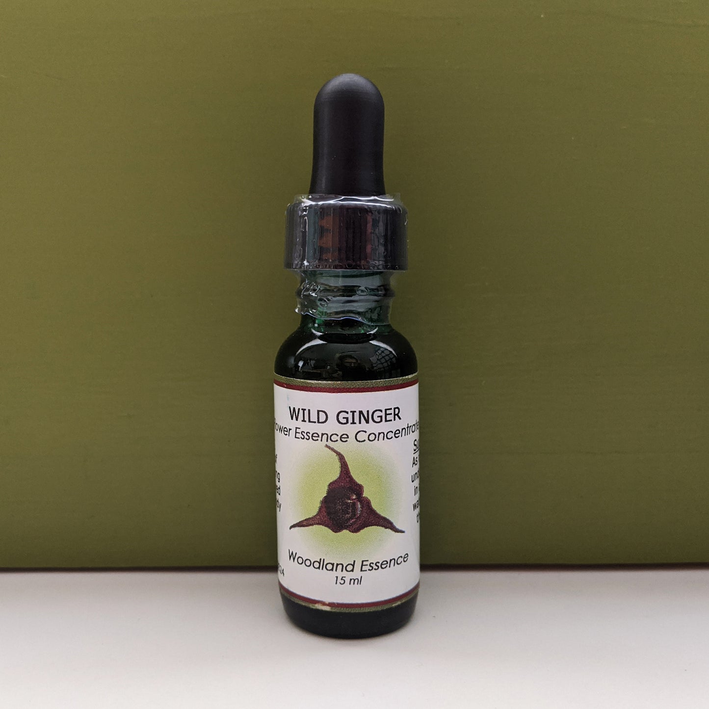 Bottle of Wild Ginger Flower Essence against green background