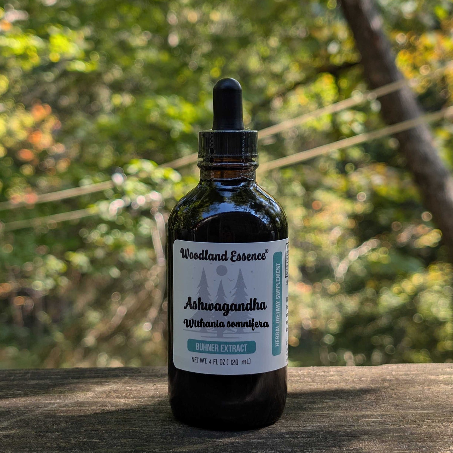 Bottle of Woodland Essence Ashwagandha extract on a wooden surface with a natural background