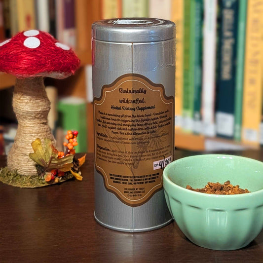 Herbal dietary supplement canister with a mushroom decoration and bowl on a wooden surface.