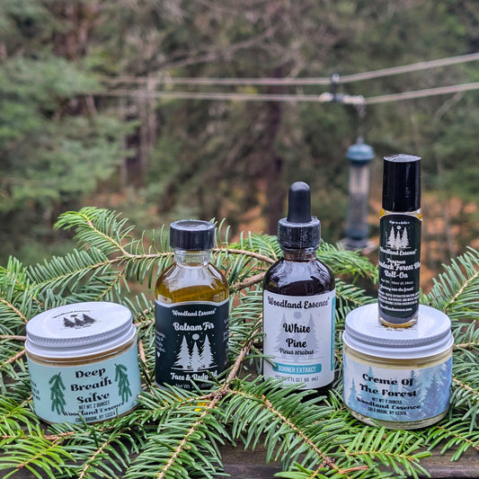 Collection of natural products including bottles and jars on a background of green foliage.