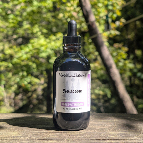 Bottle of Woodland Essence Neurocore on a wooden surface with a blurred natural background