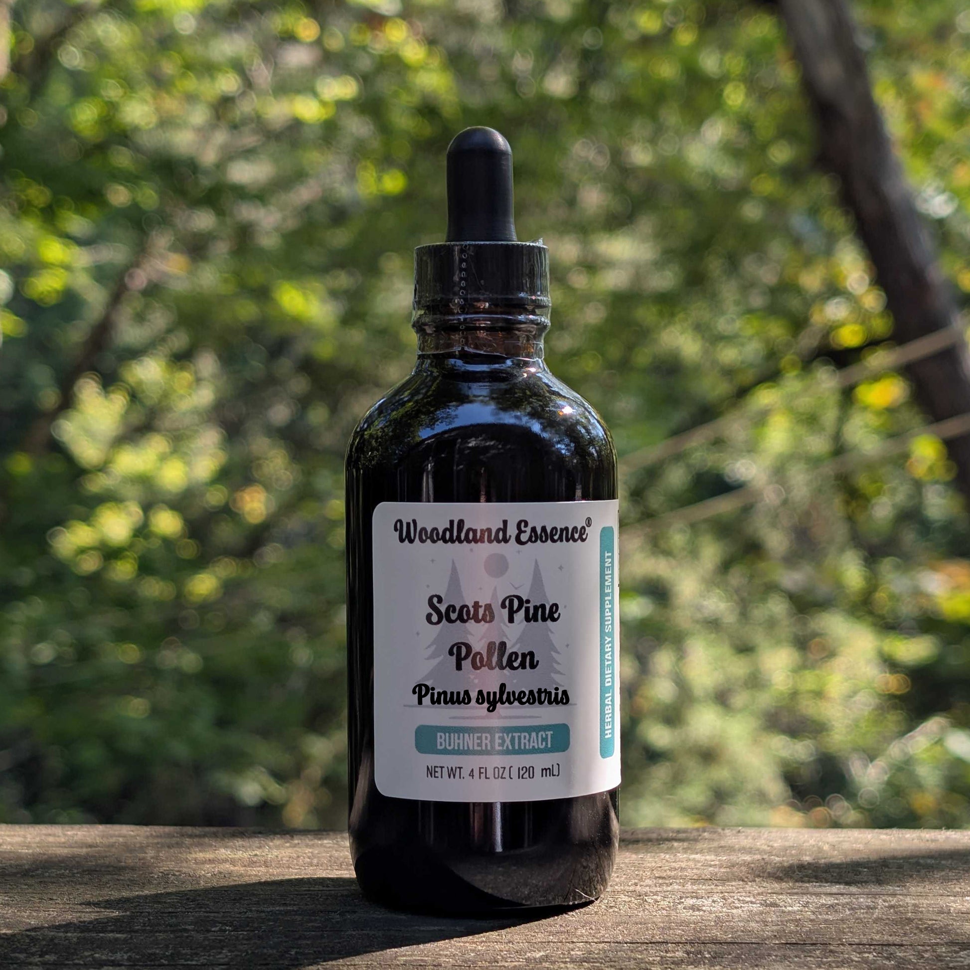 Bottle of Woodland Essence Scots Pine Pollen on a wooden surface with a blurred natural background
