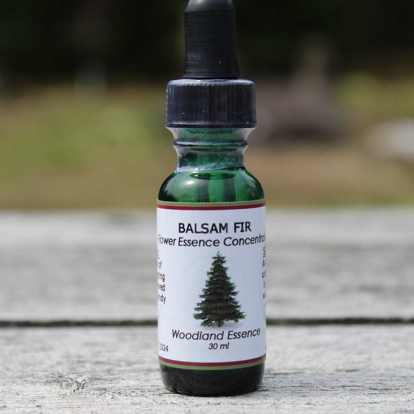 Bottle of Balsam Fir Flower Essence on picnic table 