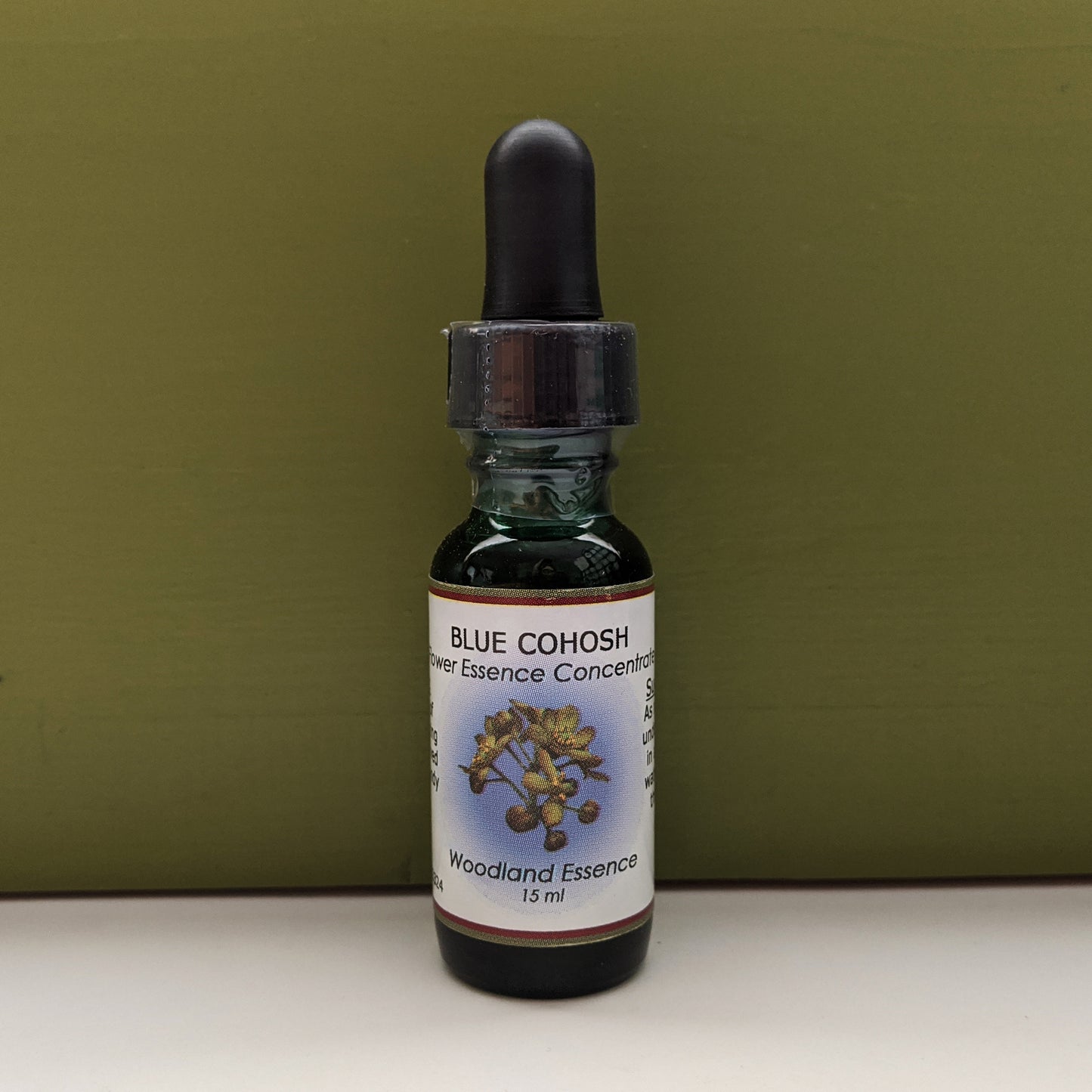 Blue Cohosh Flower Essence bottle against green background 