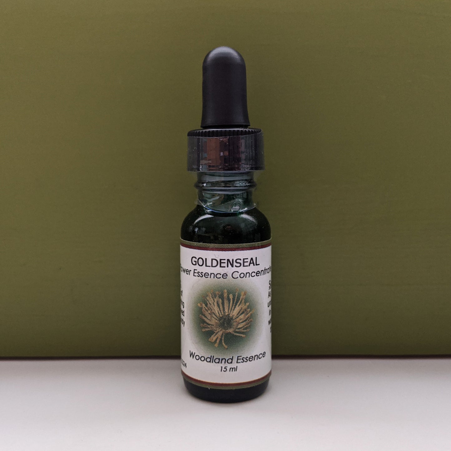 Goldenseal Flower Essence bottle against green background 