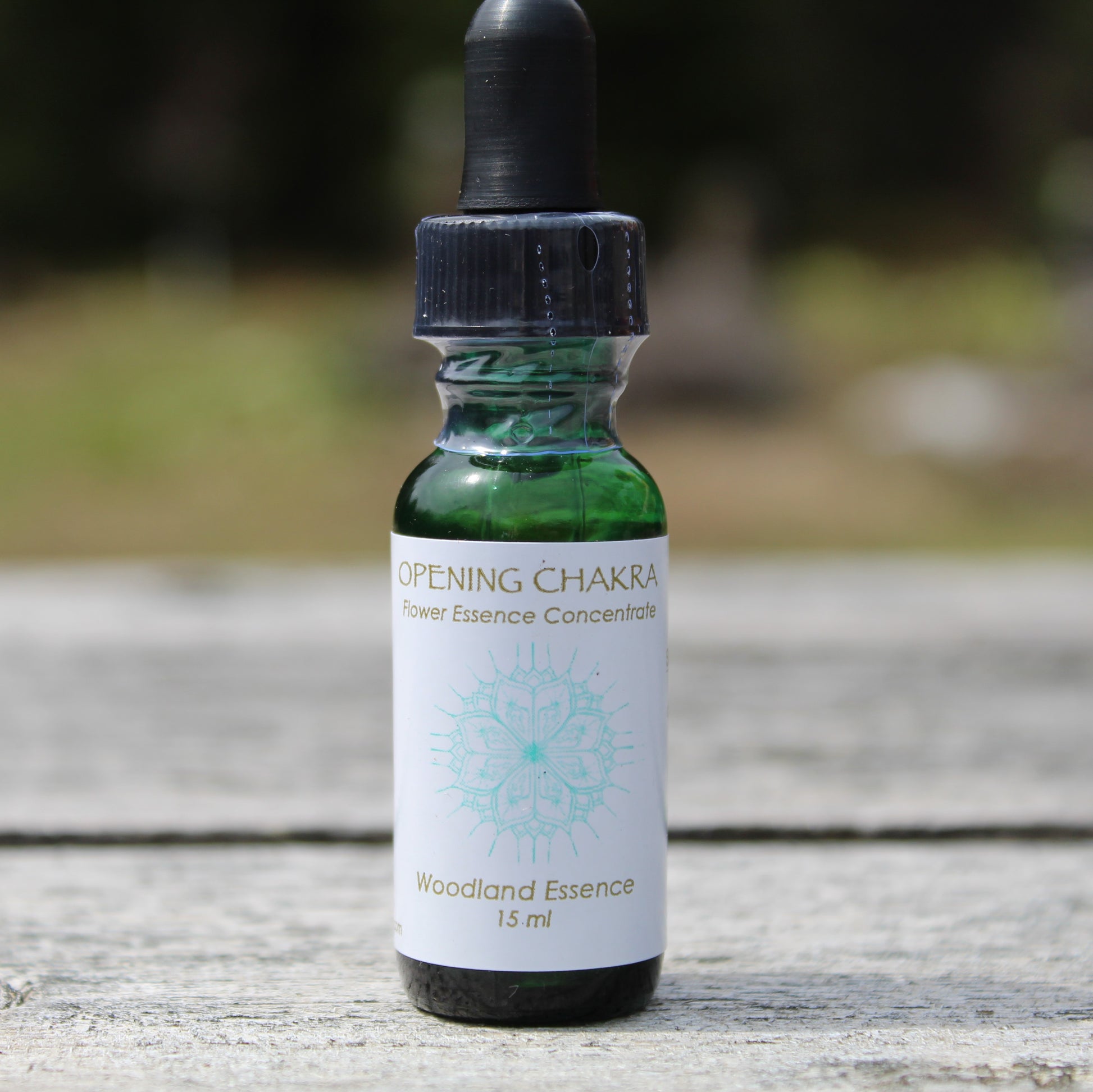 Opening Chakra Flower Essence bottle on picnic table 