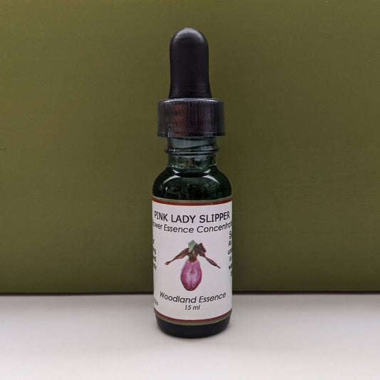 Bottle of Pink Lady's Slipper Flower Essence against green background 